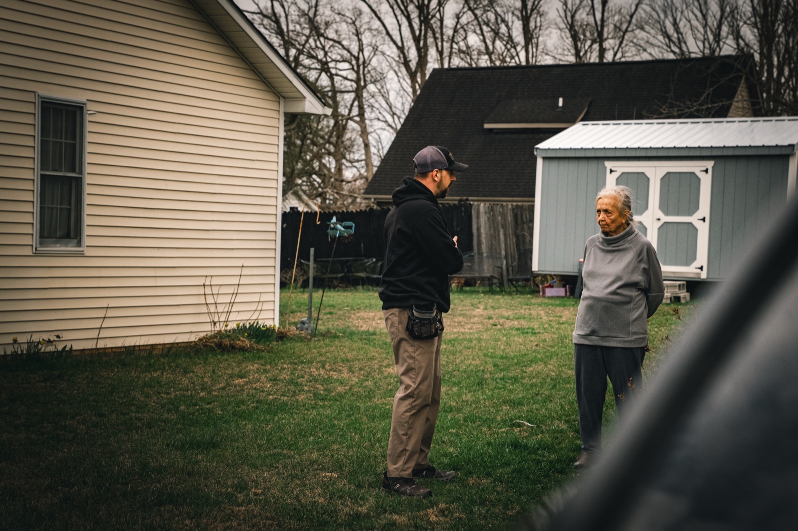 Homeowner reviewing a roof insurance claim with a contractor