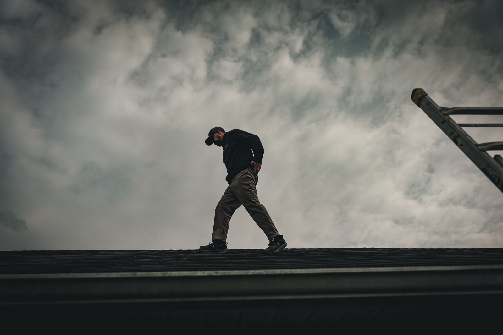 Roofer walking a residential roof